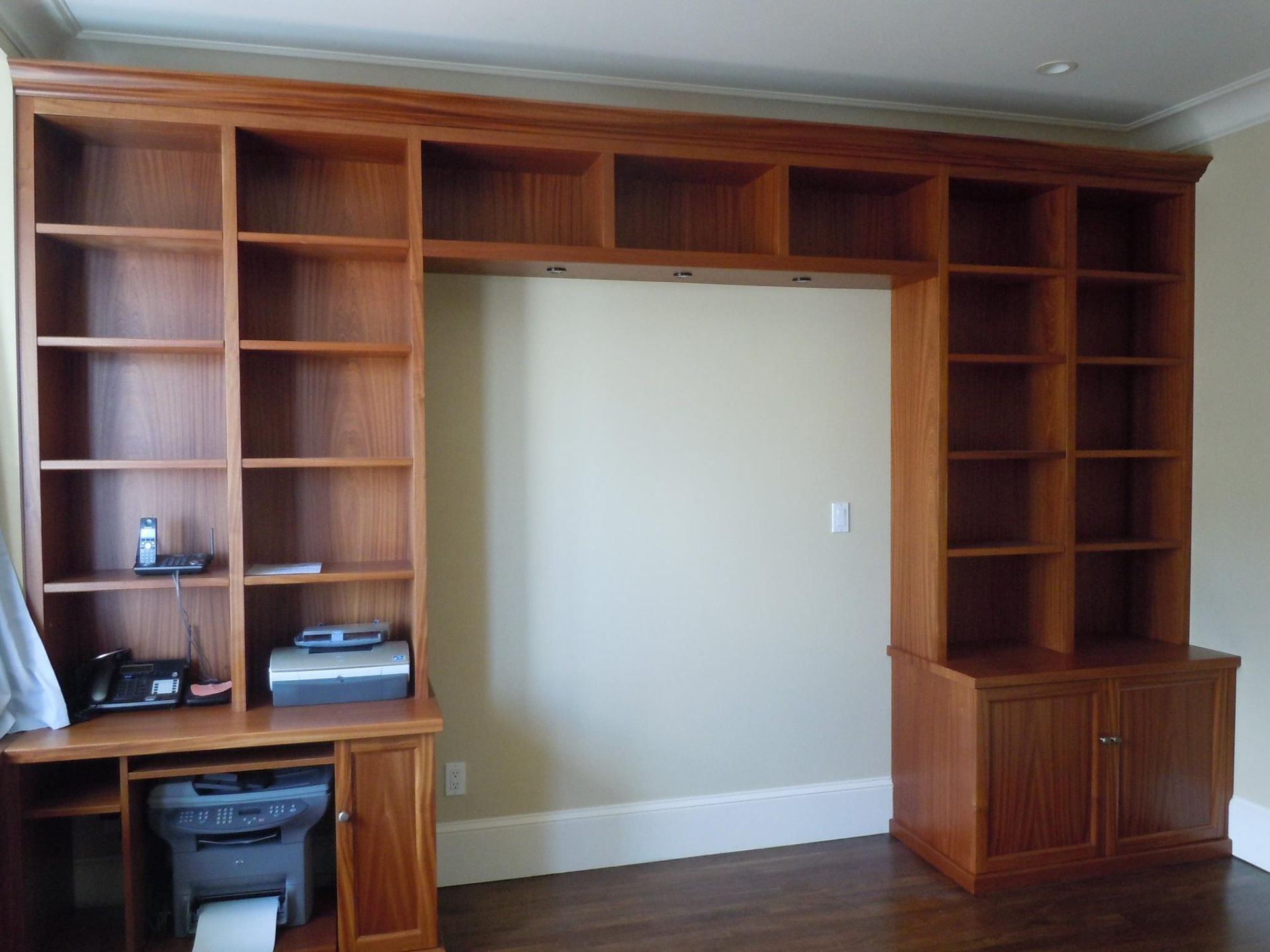 A room with lots of shelves and a printer