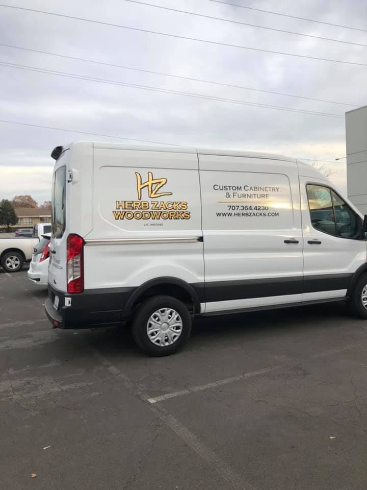 A white van is parked in a parking lot.