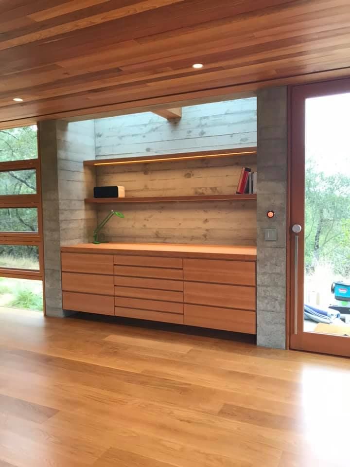 A living room with wooden floors and a sliding glass door