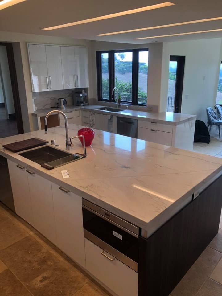 A kitchen with a large island and a sink.