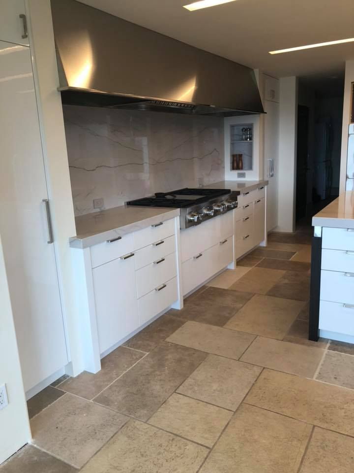 A kitchen with stainless steel appliances and white cabinets