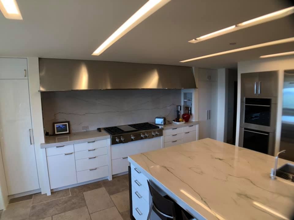 A kitchen with stainless steel appliances and white cabinets