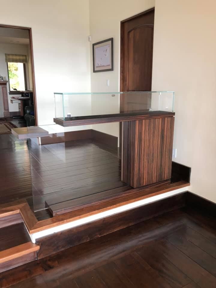 There is a glass display case in the middle of the room.