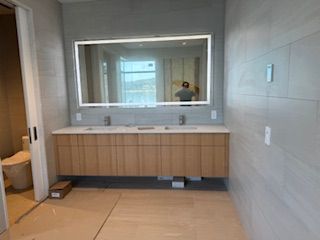 A bathroom with two sinks and a large mirror.