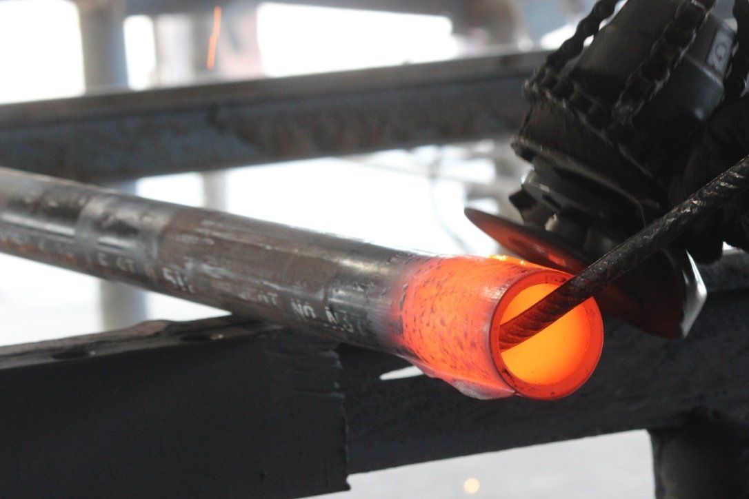 A close up of a person welding a piece of metal
