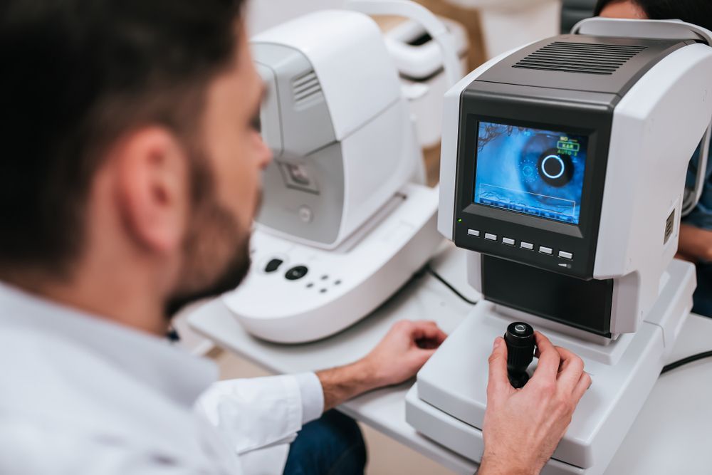 Eye Doctor Using Ophthalmic Equipment to Examine a Patient's Eye — EyeMax EyeCare in Wallsend, NSW