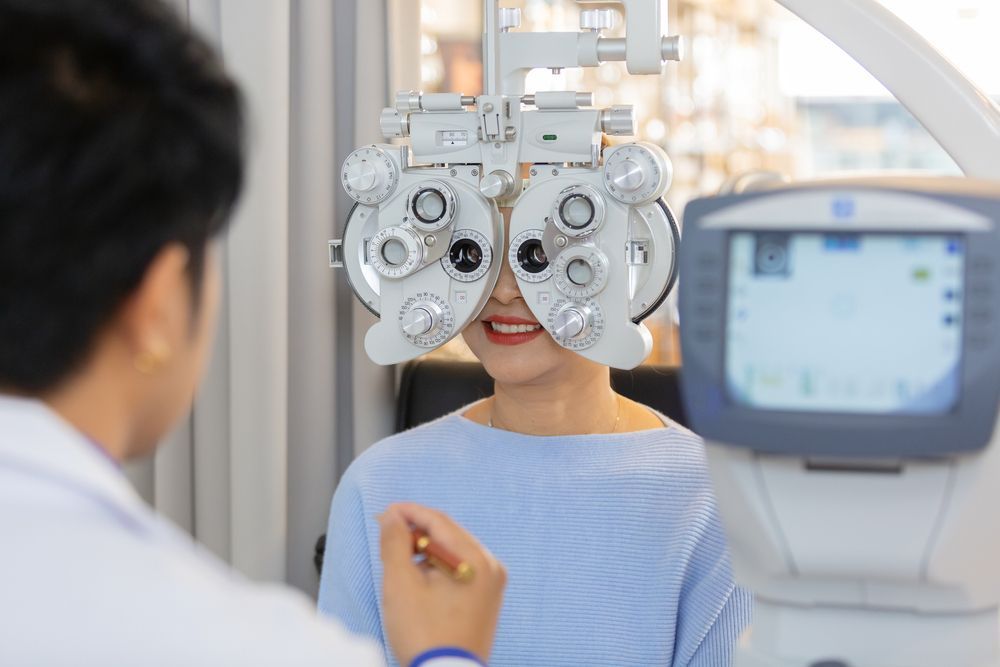 Woman Undergoing Eye Exam With Optometry Equipment — EyeMax EyeCare in Wallsend, NSW