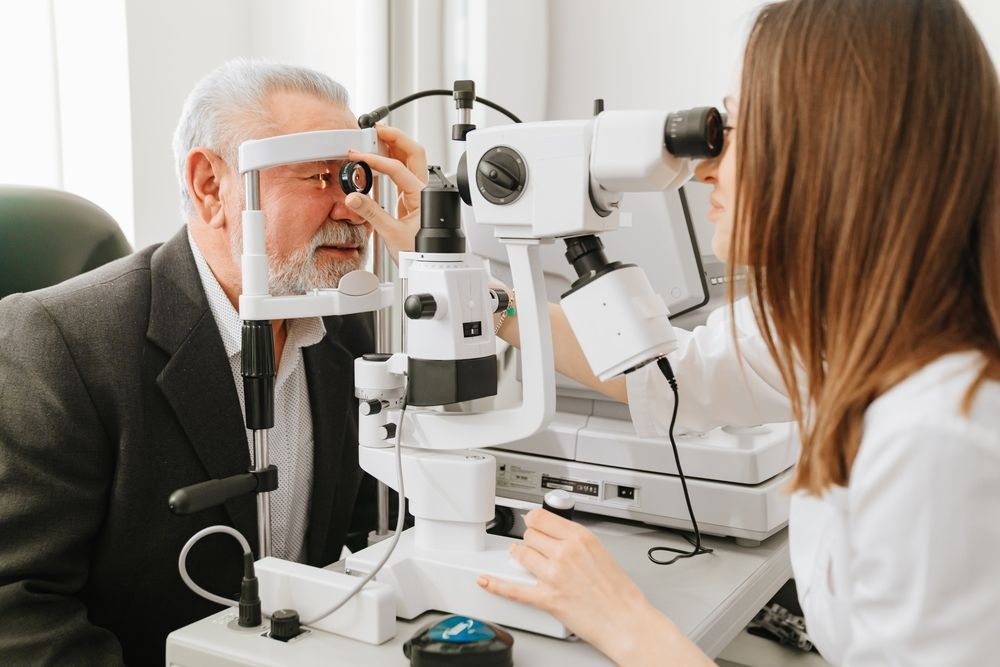 Optometrist Examining a Patient's Eyes With a Slit Lamp — EyeMax EyeCare in Wallsend, NSW