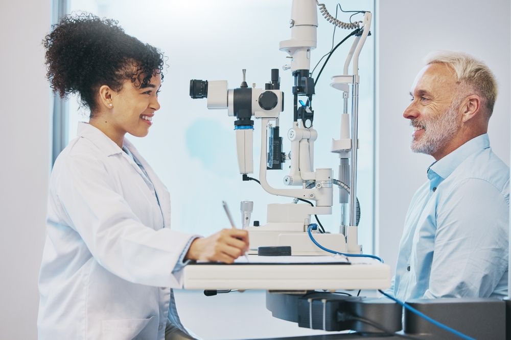Doctor Examining a Patient's Eyes With a Slit Lamp in a Medical Office — EyeMax EyeCare in Wallsend, NSW