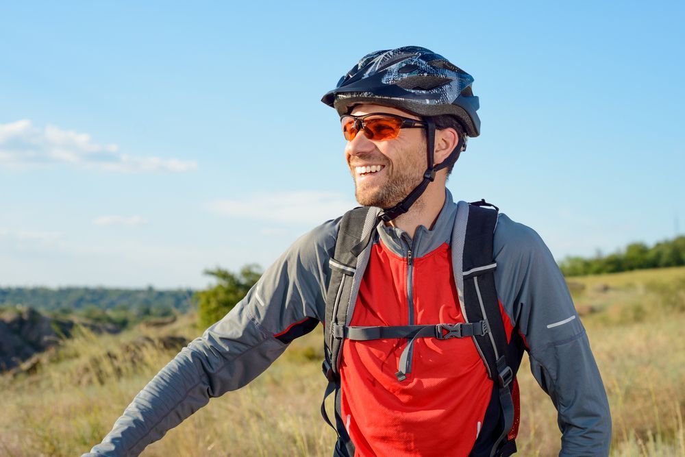Cyclist Smiles While Looking to the Side — EyeMax EyeCare in Lake Macquarie, NSW