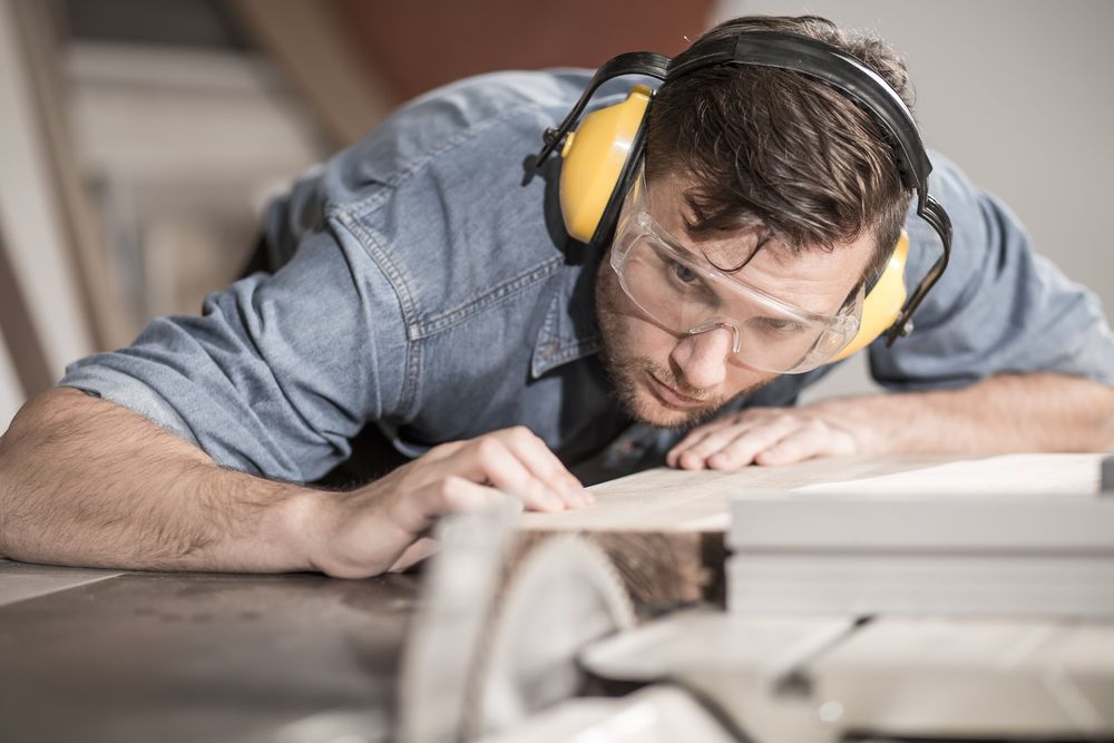 Person Wearing Safety Gear Uses a Table Saw in a Workshop — EyeMax EyeCare in Lake Macquarie, NSW