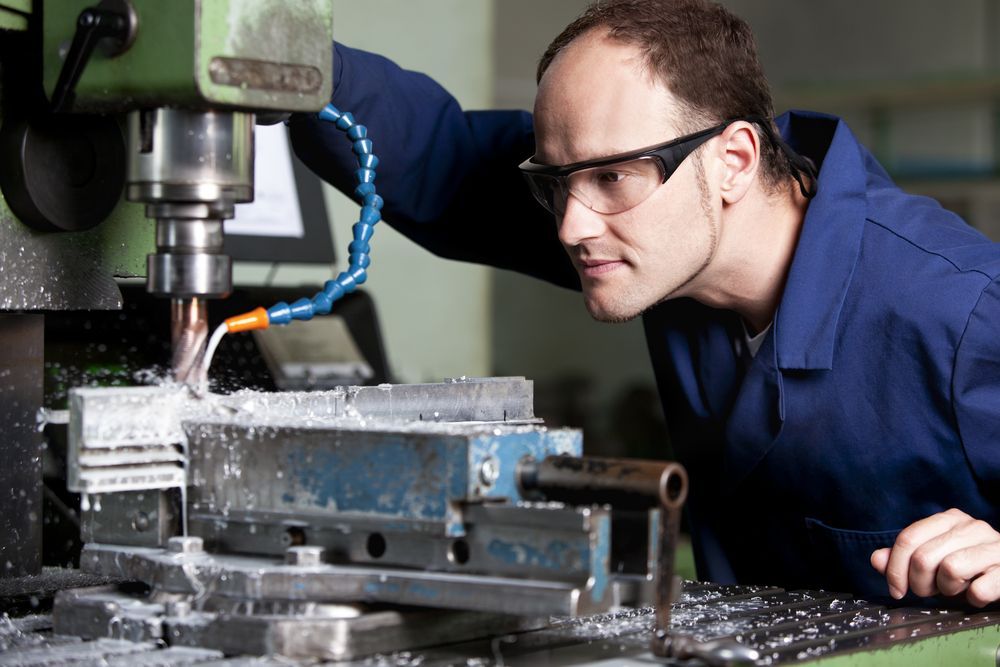 Man Wearing Safety Glasses Operates a Milling Machine — EyeMax EyeCare in Cessnock, NSW