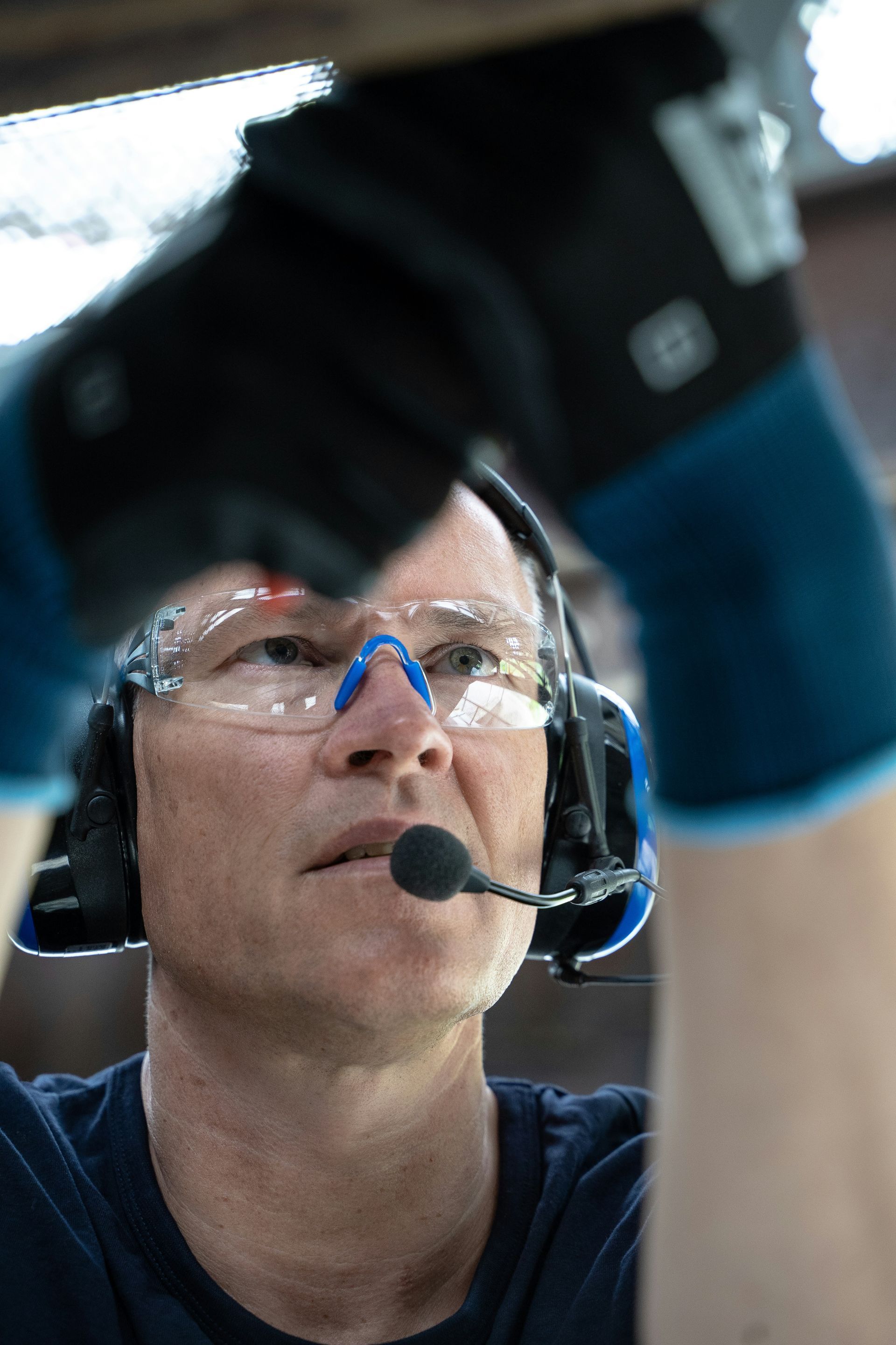Man Wearing Safety Glasses and Headset Working on a Project — EyeMax EyeCare in Newcastle, NSW