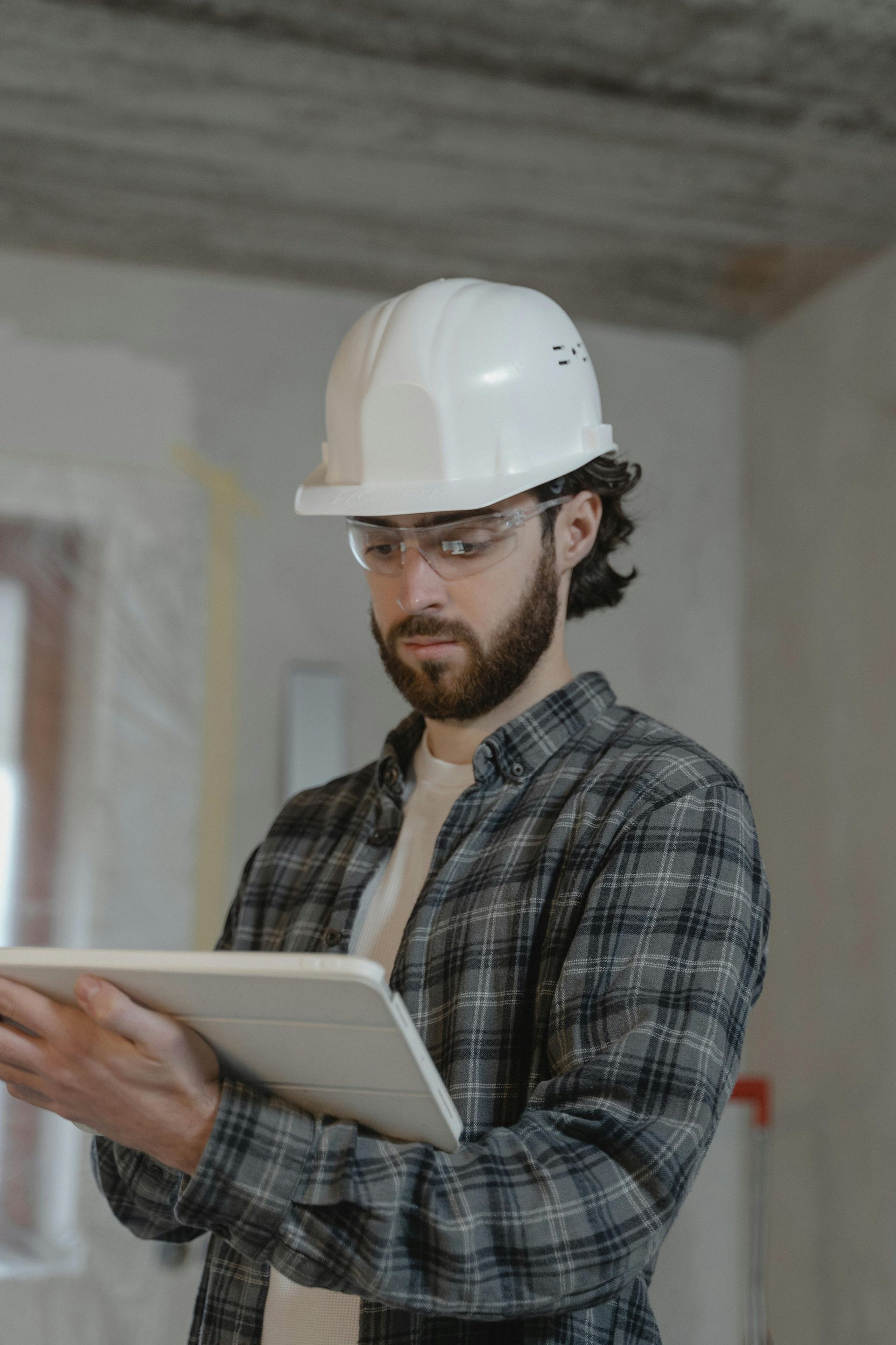 Construction Worker With a Beard, Wearing a Hard Hat and Safety Glasses — EyeMax EyeCare in Newcastle, NSW
