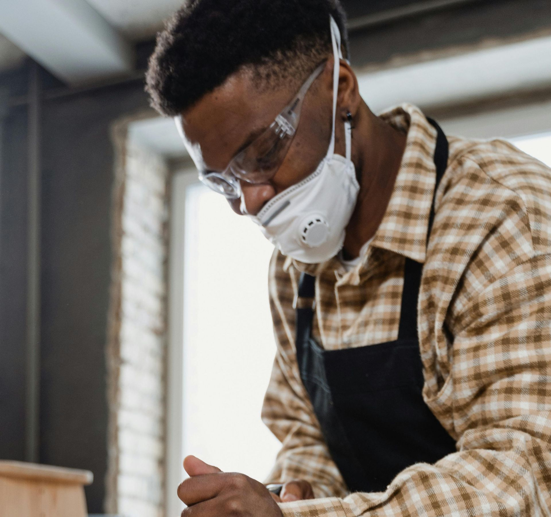 Person in Safety Glasses and a Mask Working in a Workshop — EyeMax EyeCare in Singleton, NSW