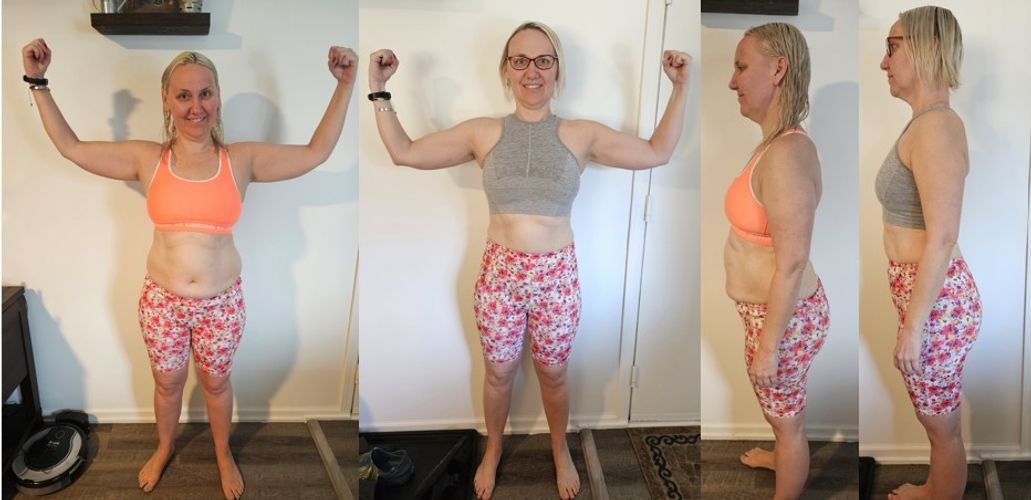 A woman is standing in a room with her arms in the air.