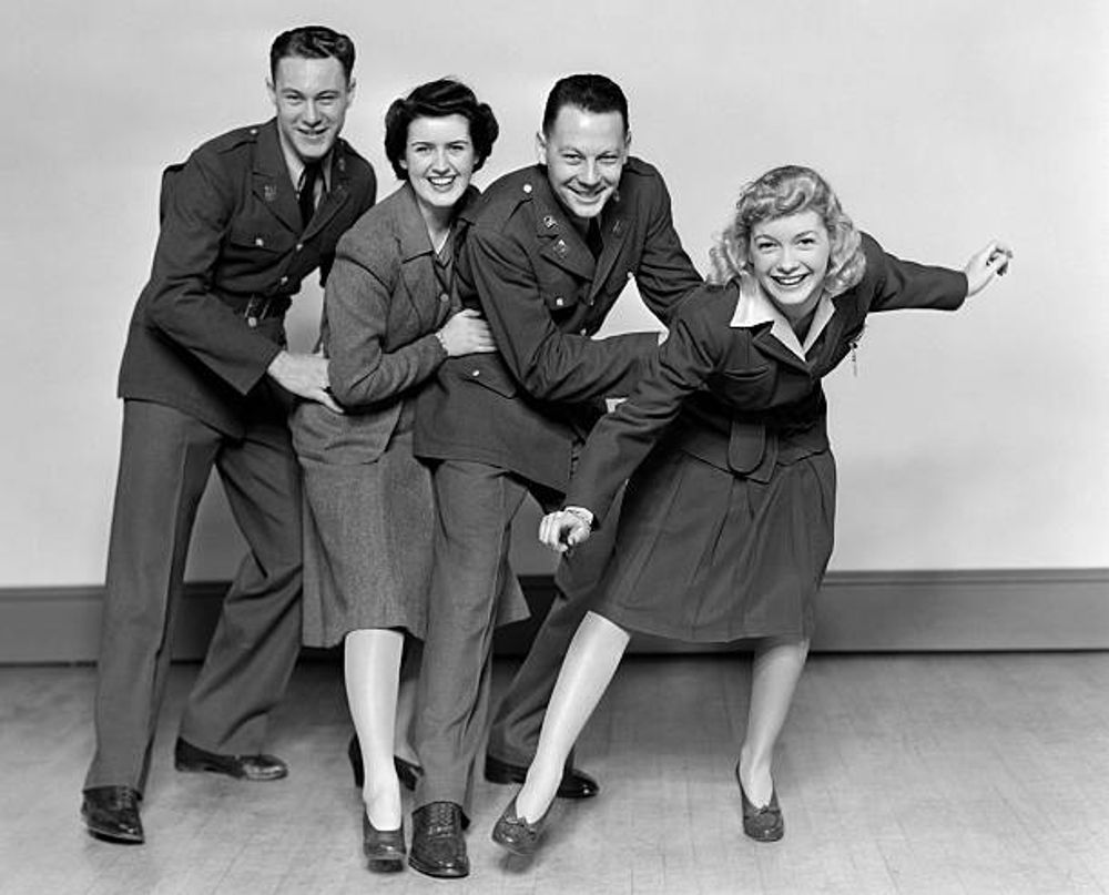 A group of people in military uniforms are posing for a picture