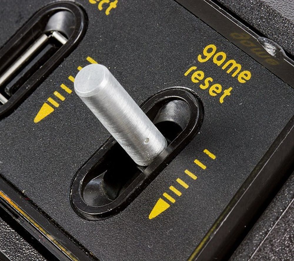 A close up of a game reset button on a device