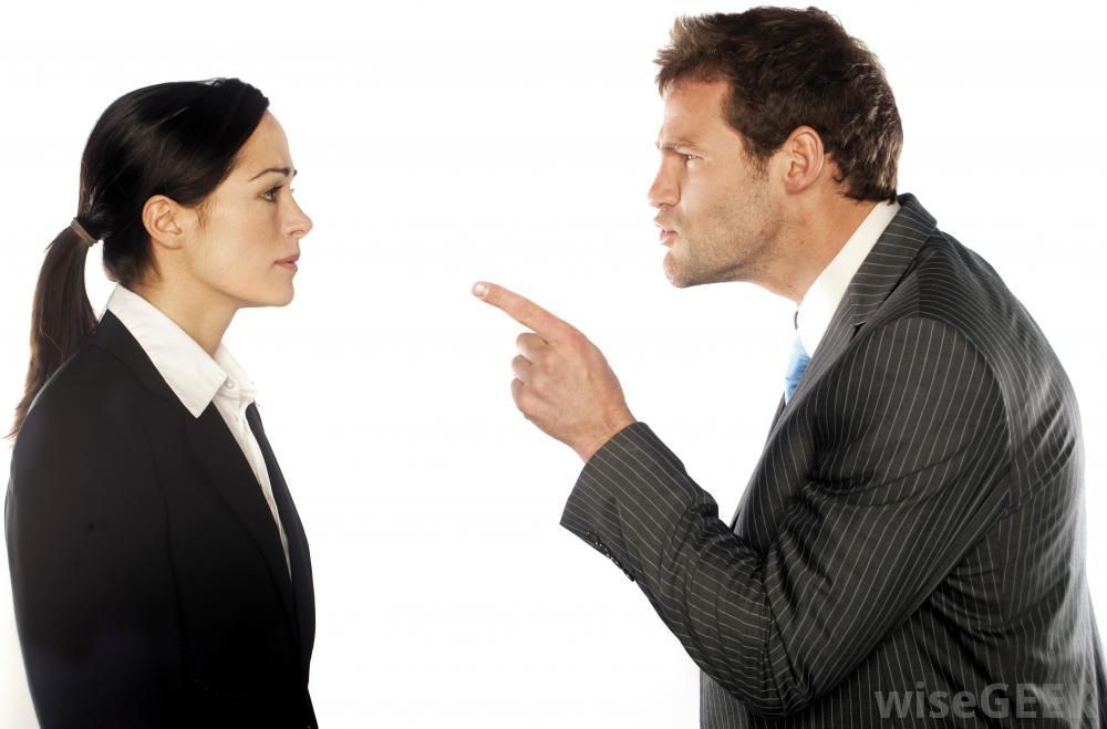 A man in a suit is pointing at a woman in a business suit