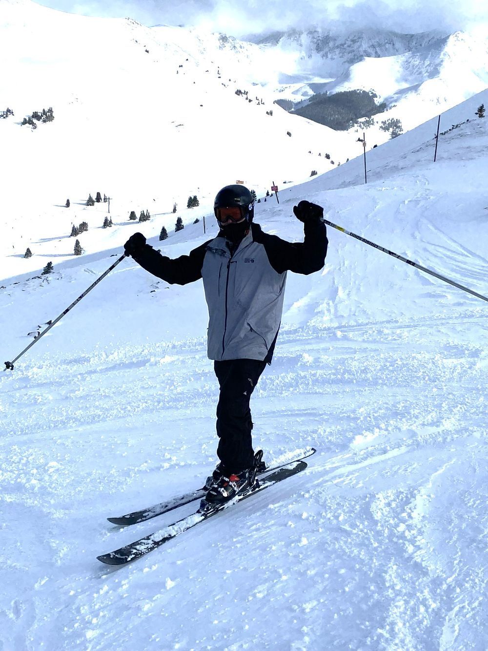 A person is skiing down a snow covered slope