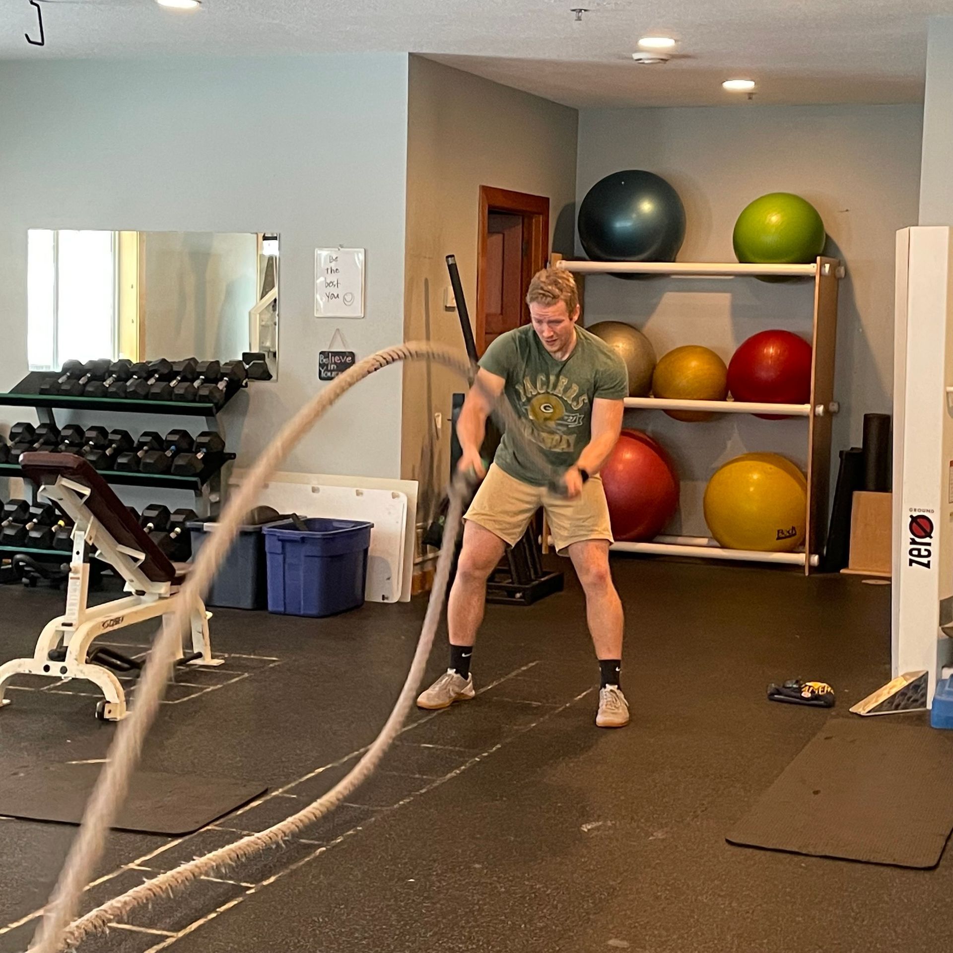 A man is using a rope in a gym