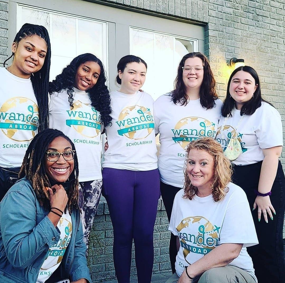 Group of seven people wearing white