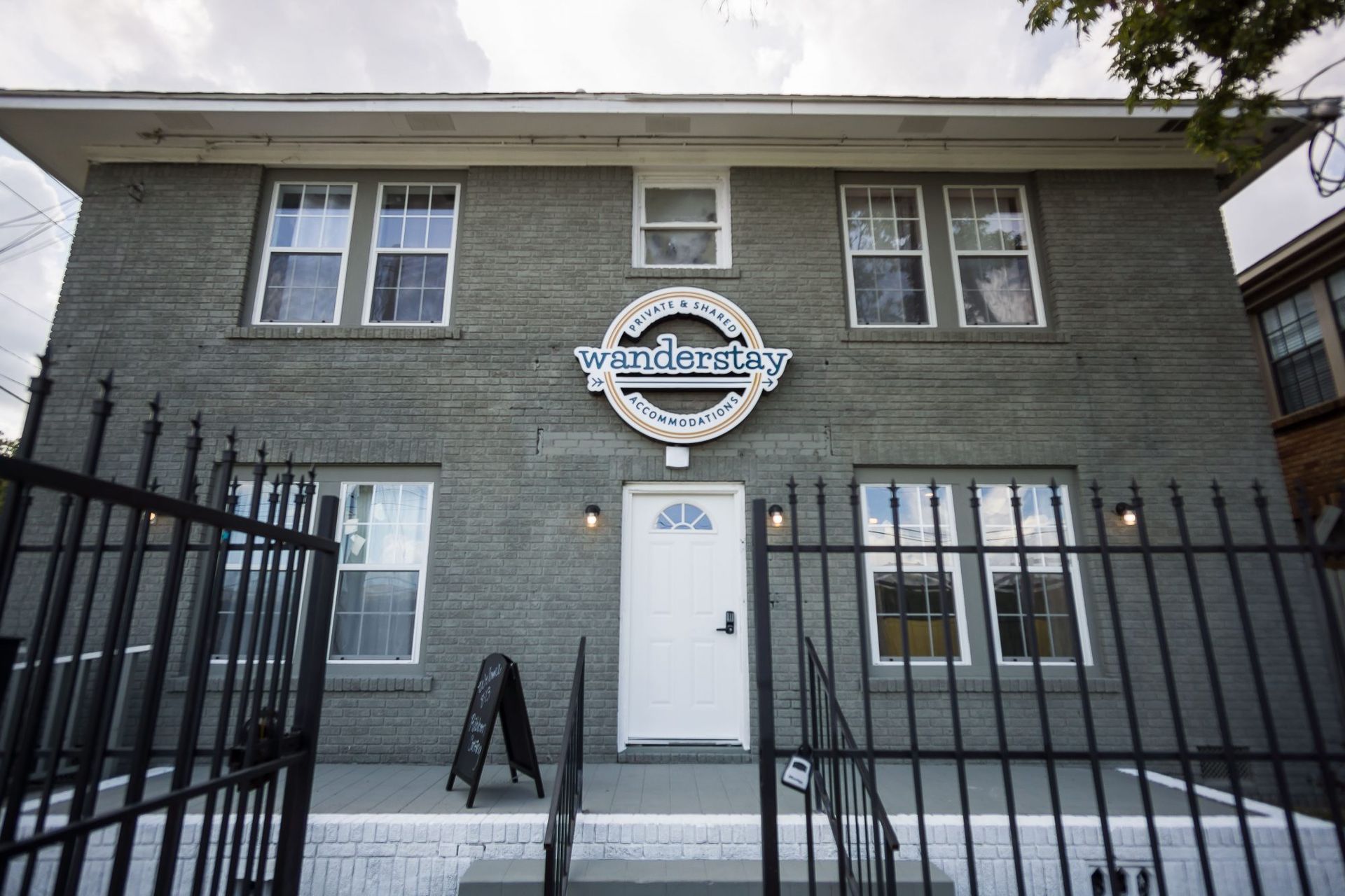 Gray two-story building with a circular sign