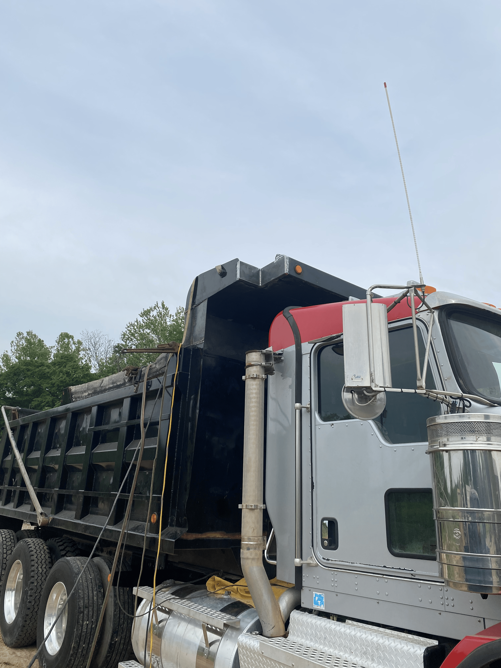 A dump truck is parked on the side of the road.