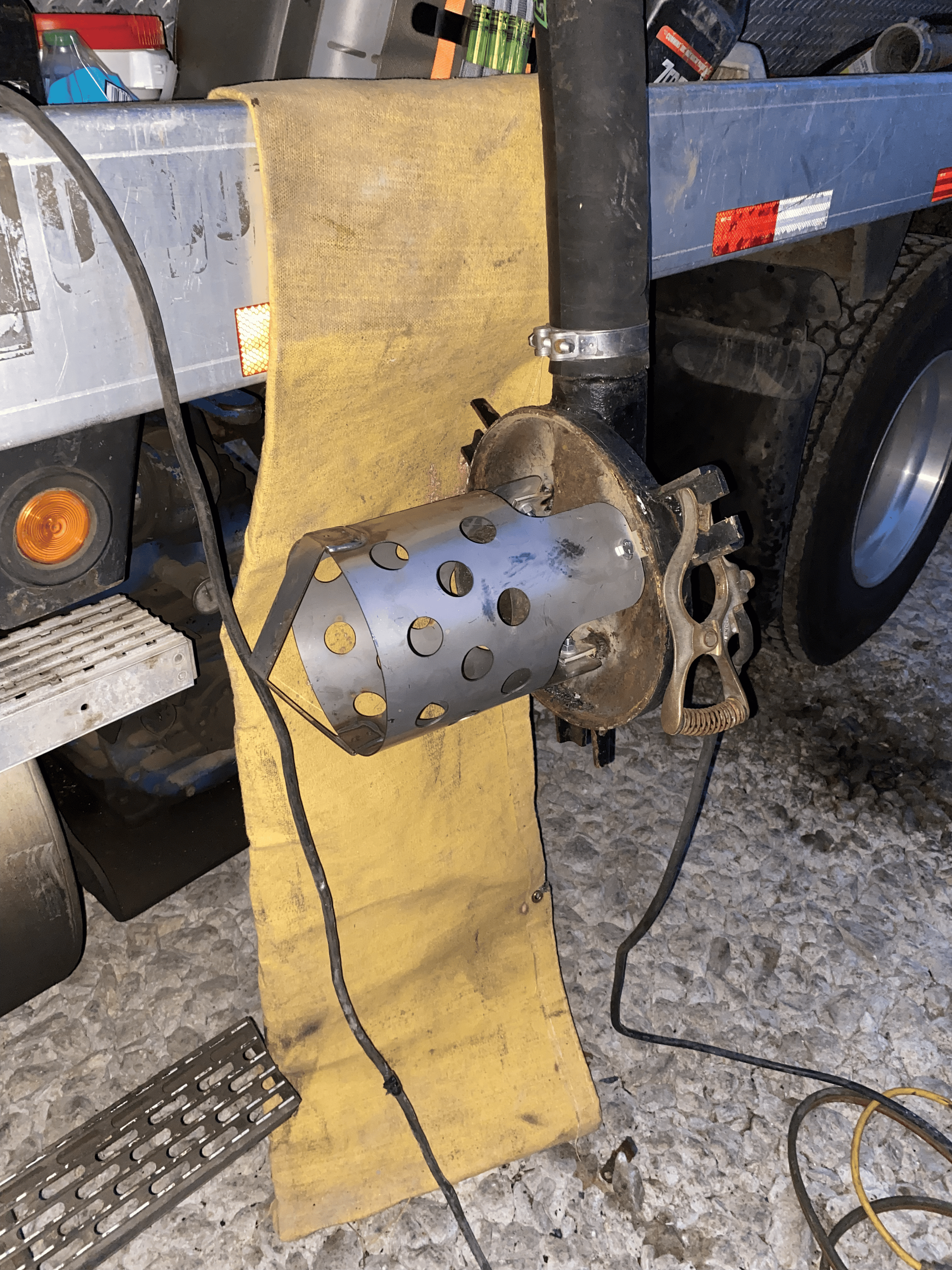 A piece of metal is sitting on the ground next to a truck.