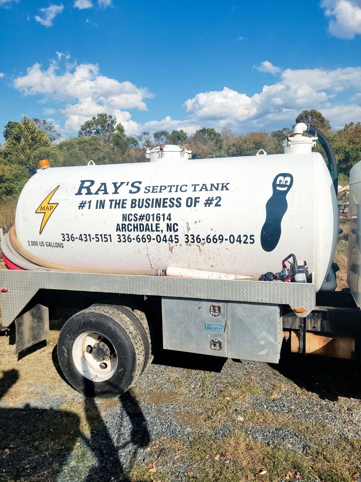 Ray's Septic Tank truck with lightning bolt logo and cartoon poop. In Archdale, NC.