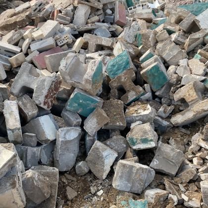 Pile of broken concrete debris with various colors.