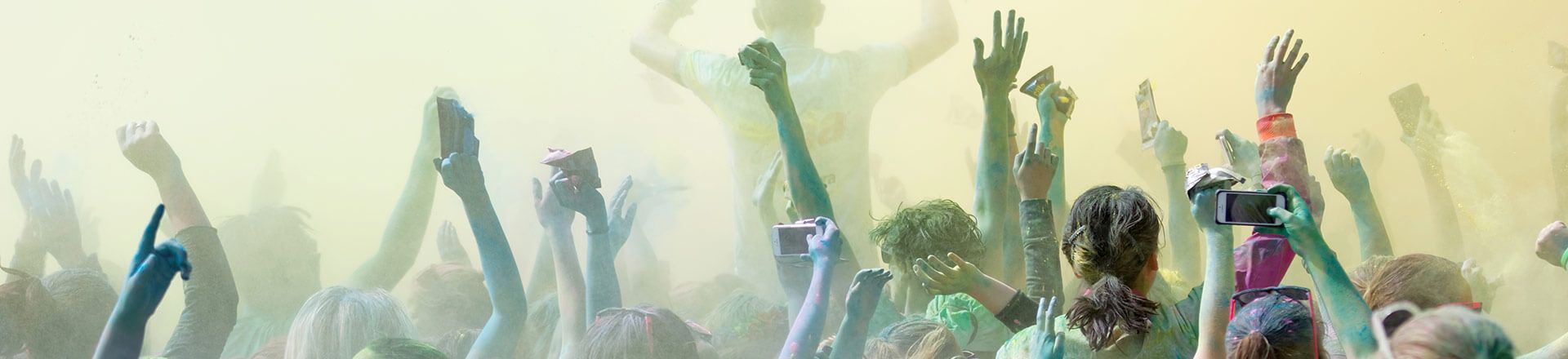 a crowd of people with their hands in the air