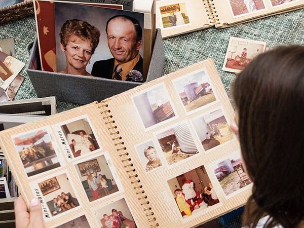 a woman is looking at a family photo album .