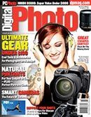a woman wearing headphones is holding a camera on the cover of a digital photo magazine .