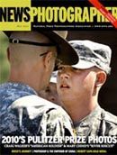 two soldiers are standing next to each other on the cover of a magazine .
