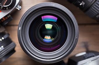a close up of a camera lens on a wooden table .