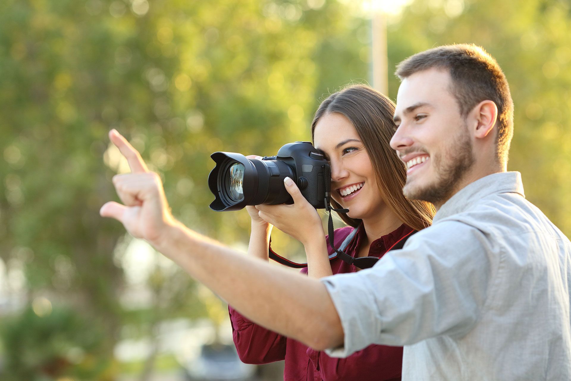 a woman taking a picture with a canon camera