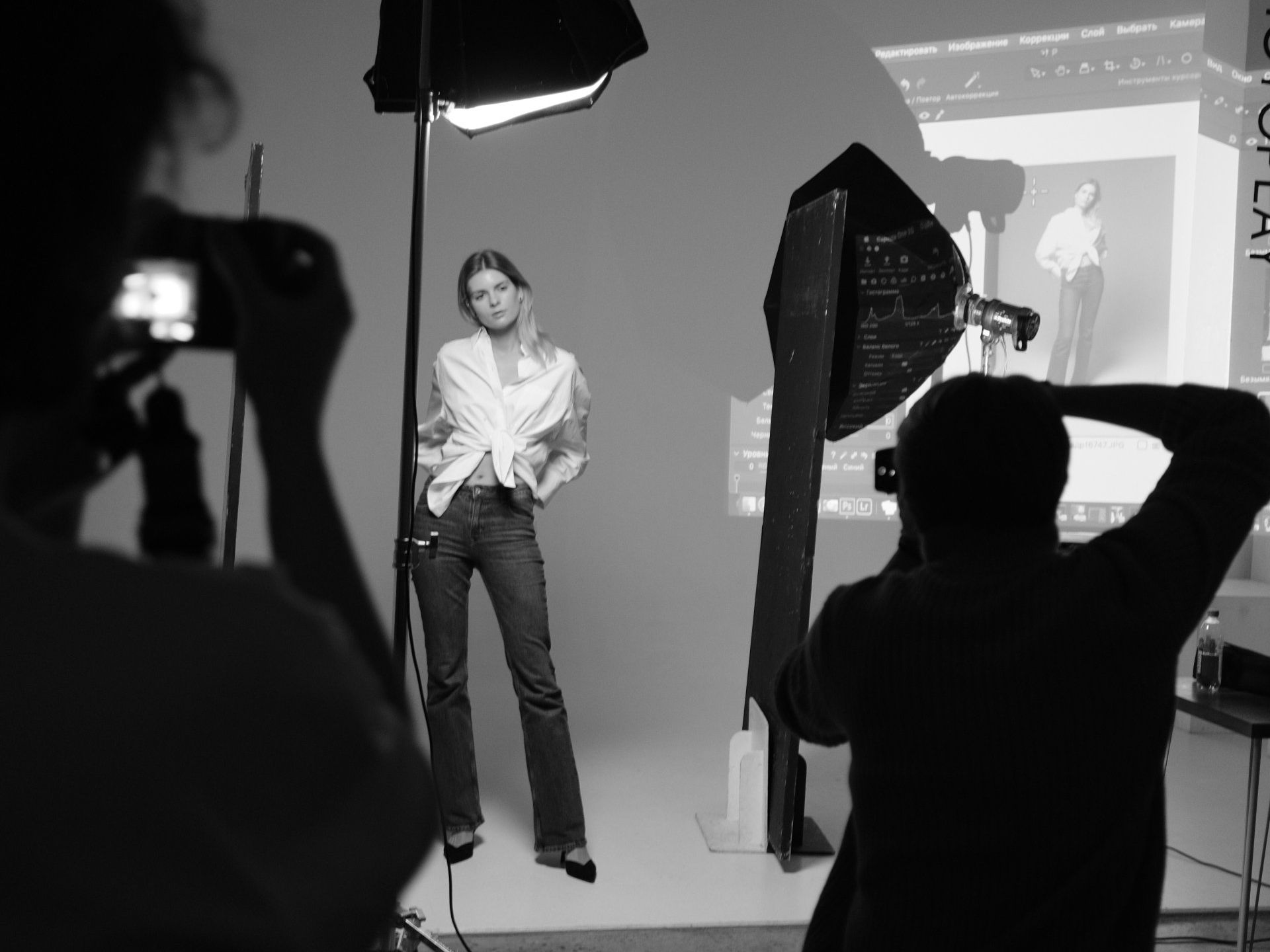 a black and white photo of a woman being photographed