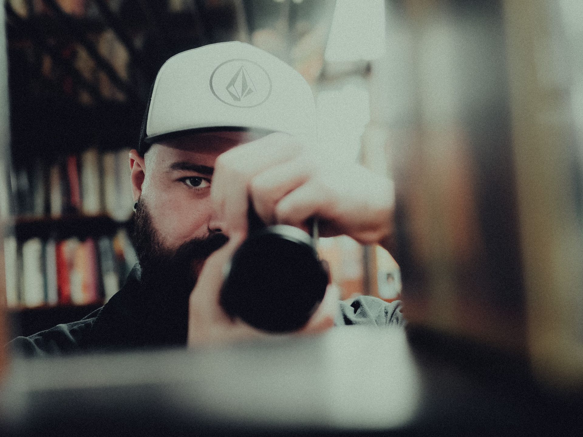 a man with a beard is taking a picture of himself