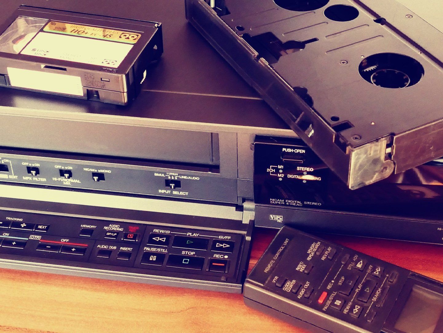 a vhs tape recorder and remote control on a table