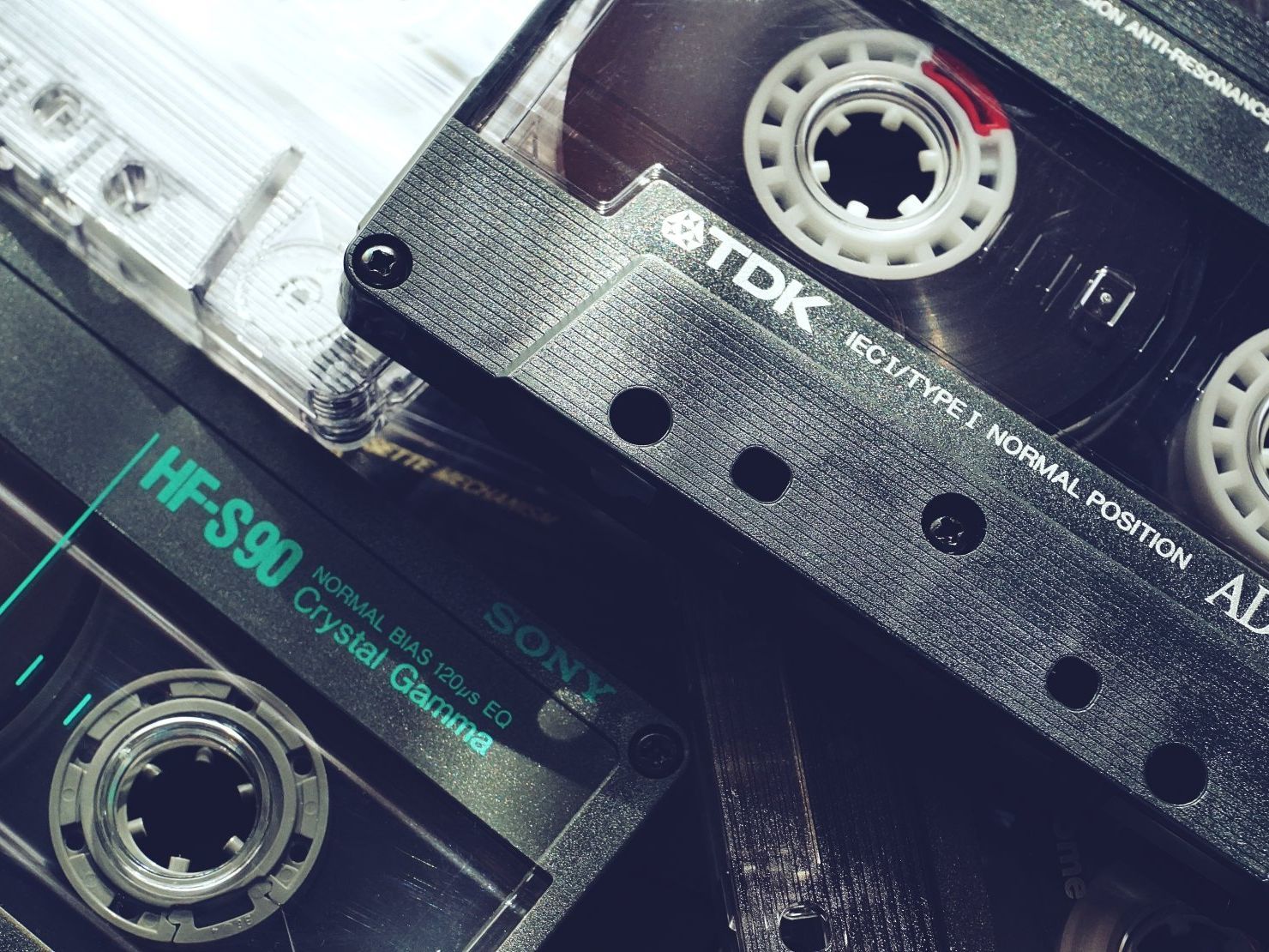 a tdk cassette tape sits next to a sony cassette tape