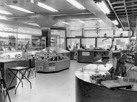 a black and white photo of the inside of a store .