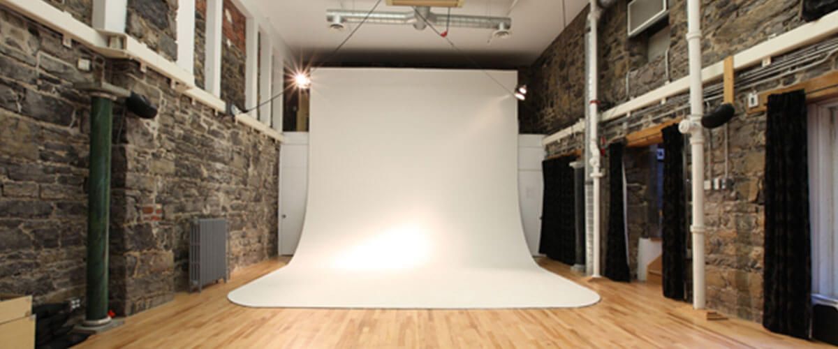 an empty room with a large white screen in the middle