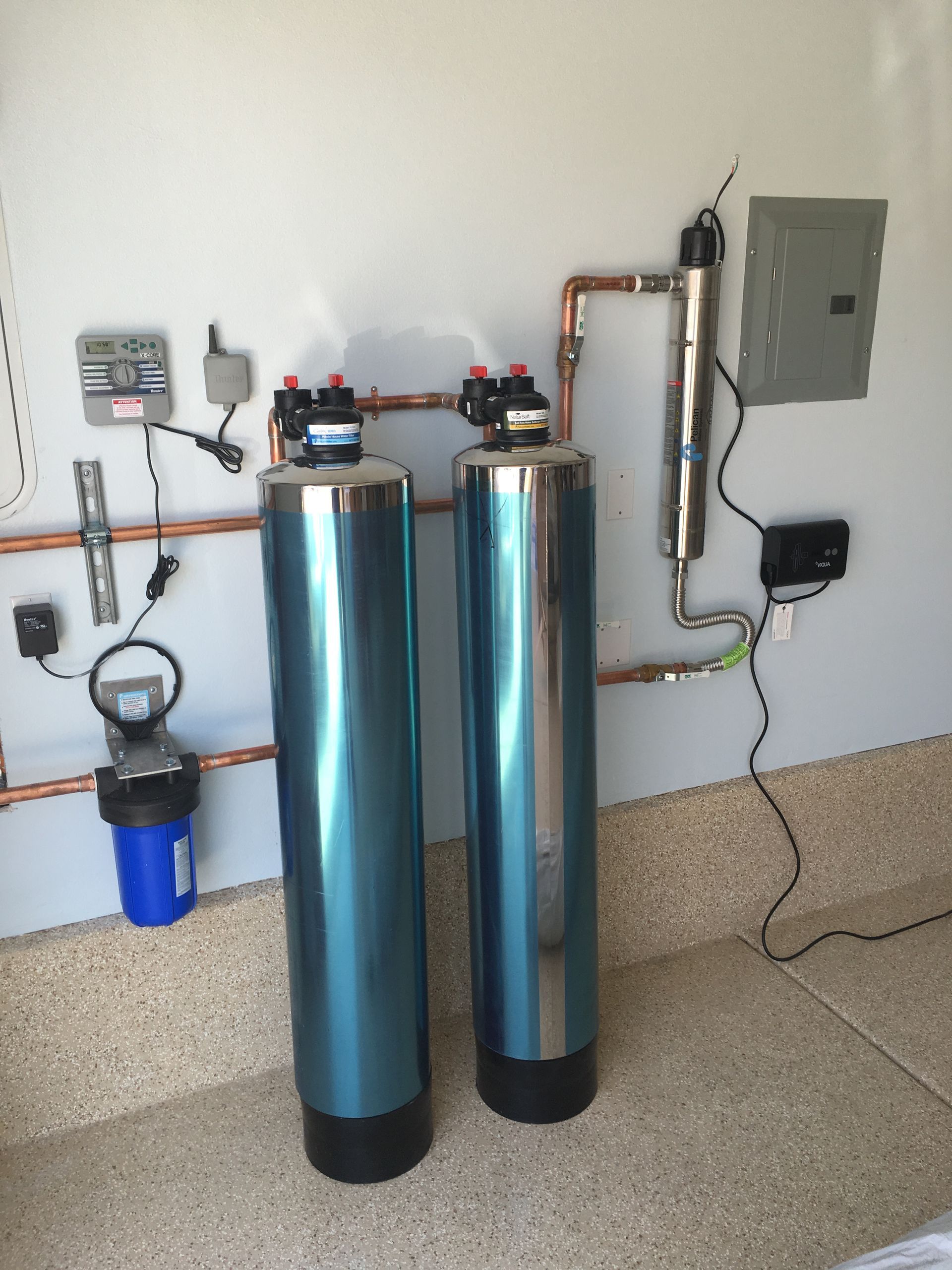 Two stainless steel water filters are sitting next to each other