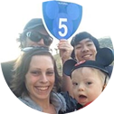 a family is posing for a picture with a sign that says highway 5 .