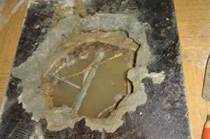 a hole in the wall with a hose coming out of it .