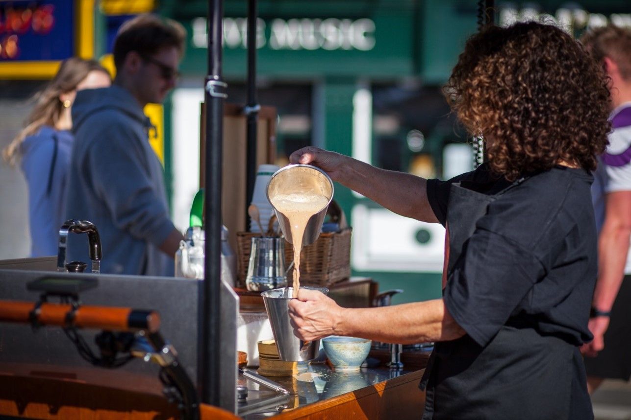 A woman is pouring a liquid into a cone.