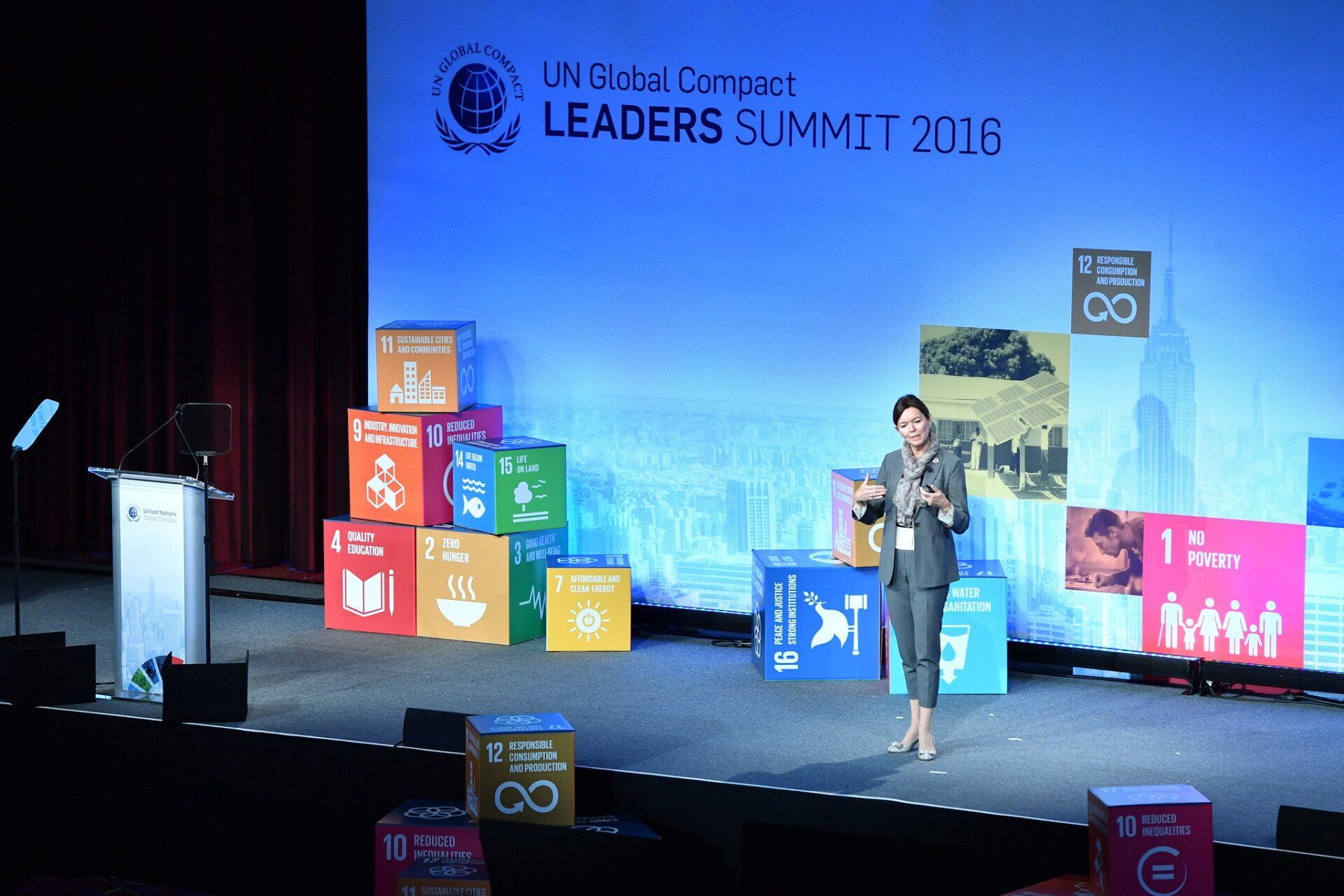 A woman is giving a speech at the leaders summit 2016