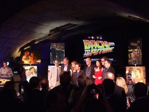 A group of people standing in front of a back to the future sign