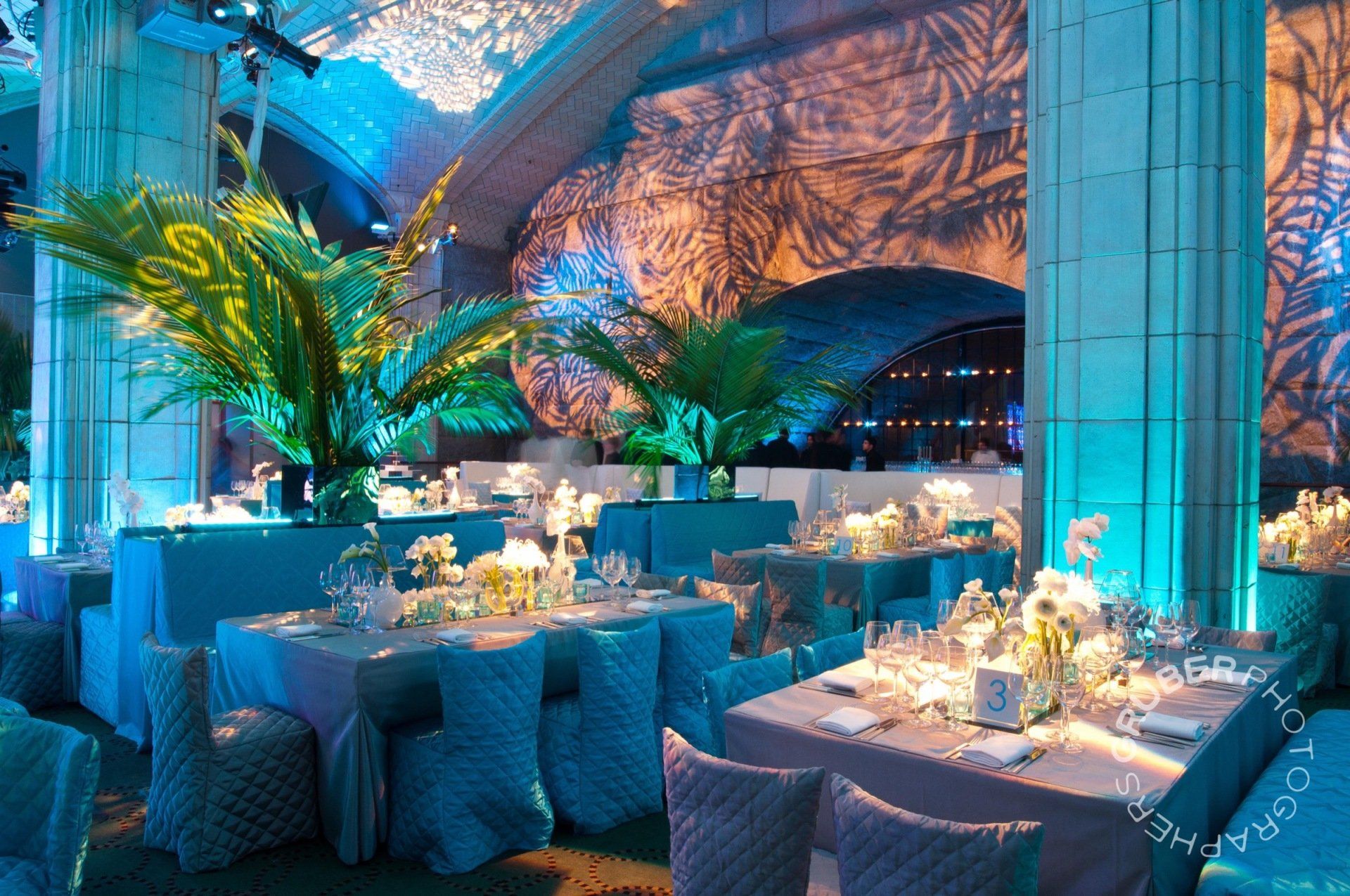A large room with tables and chairs set up for a party